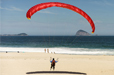 paraglider-red_landing-on-beach-2